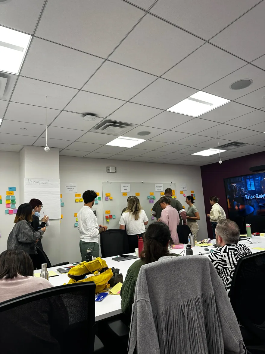 Cross-functional ideation workshop with sticky notes on the wall